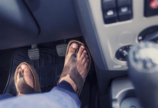 Closeup Feet Driving in Sandles