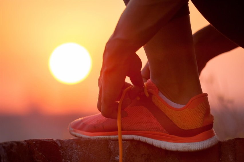 Someone Tying Shoelaces with Sunset